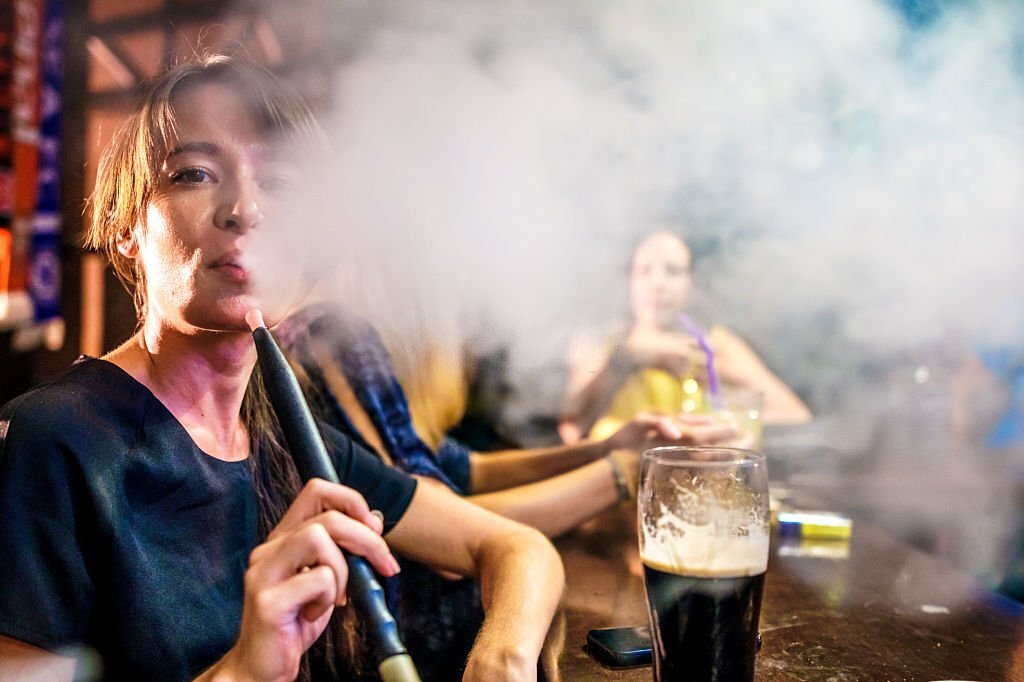 Woman smoking hookah in the bar